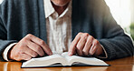 Religion, old man and hands in house with bible, theology and sacred with spiritual learning. Christian, reading and elderly person with holy book, scripture study and wisdom insight in retirement.