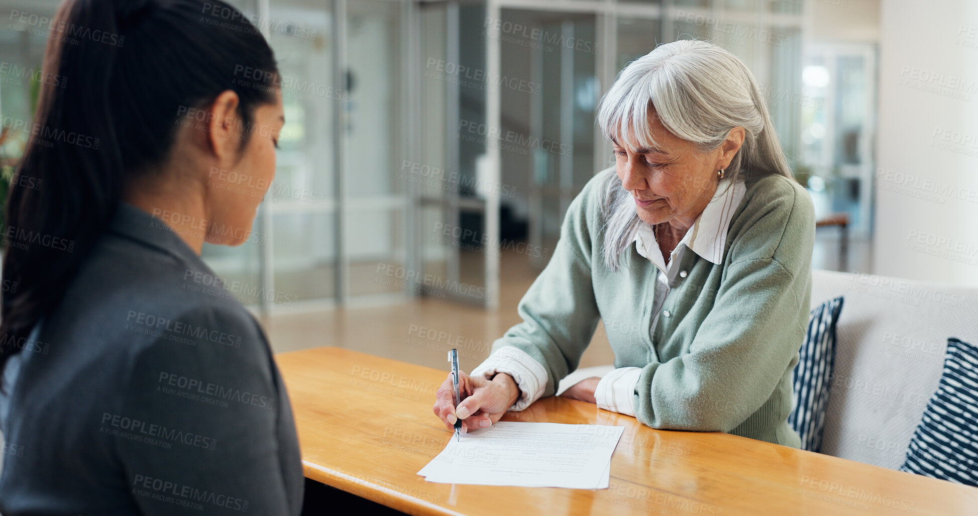 Buy stock photo Paperwork, signature and old woman in office with insurance agent, application or legal consent form. Broker, senior person and sign document in consultation for policy cover, terms and conditions.