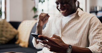 Buy stock photo Hands, phone and celebration with fist pump on sofa for streaming sport, goal or success in home. African person, happy and app on smartphone, football game or success with online betting at house