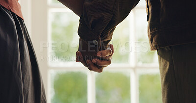 Buy stock photo Trust, holding hands and couple at window with love, commitment and security in relationship. Loyalty, partner and people in house with safety, caring connection and romantic moment in marriage.