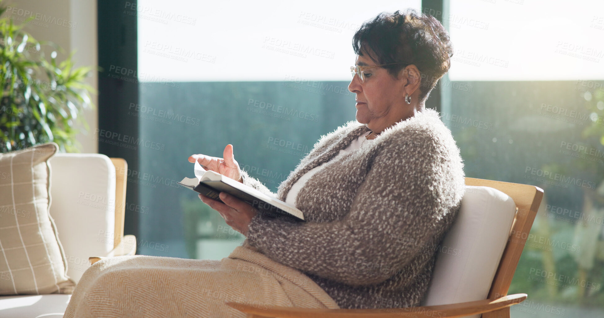 Buy stock photo Religion, reading or old woman in home with bible, theology or sacred text with spiritual learning. Christian, review or senior person with holy book, scripture study or wisdom insight in retirement.