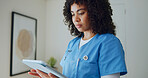 Nurse, woman and reading in clinic with tablet, online research and medical report for telehealth. Healthcare worker, person and browsing in hospital with tech, schedule and patient care records.