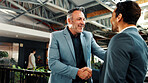 Man, realtor and handshake in office for smile, property management or service deal. Client, real estate agent and shaking hands in agency for commission update, meeting and conversation for greeting