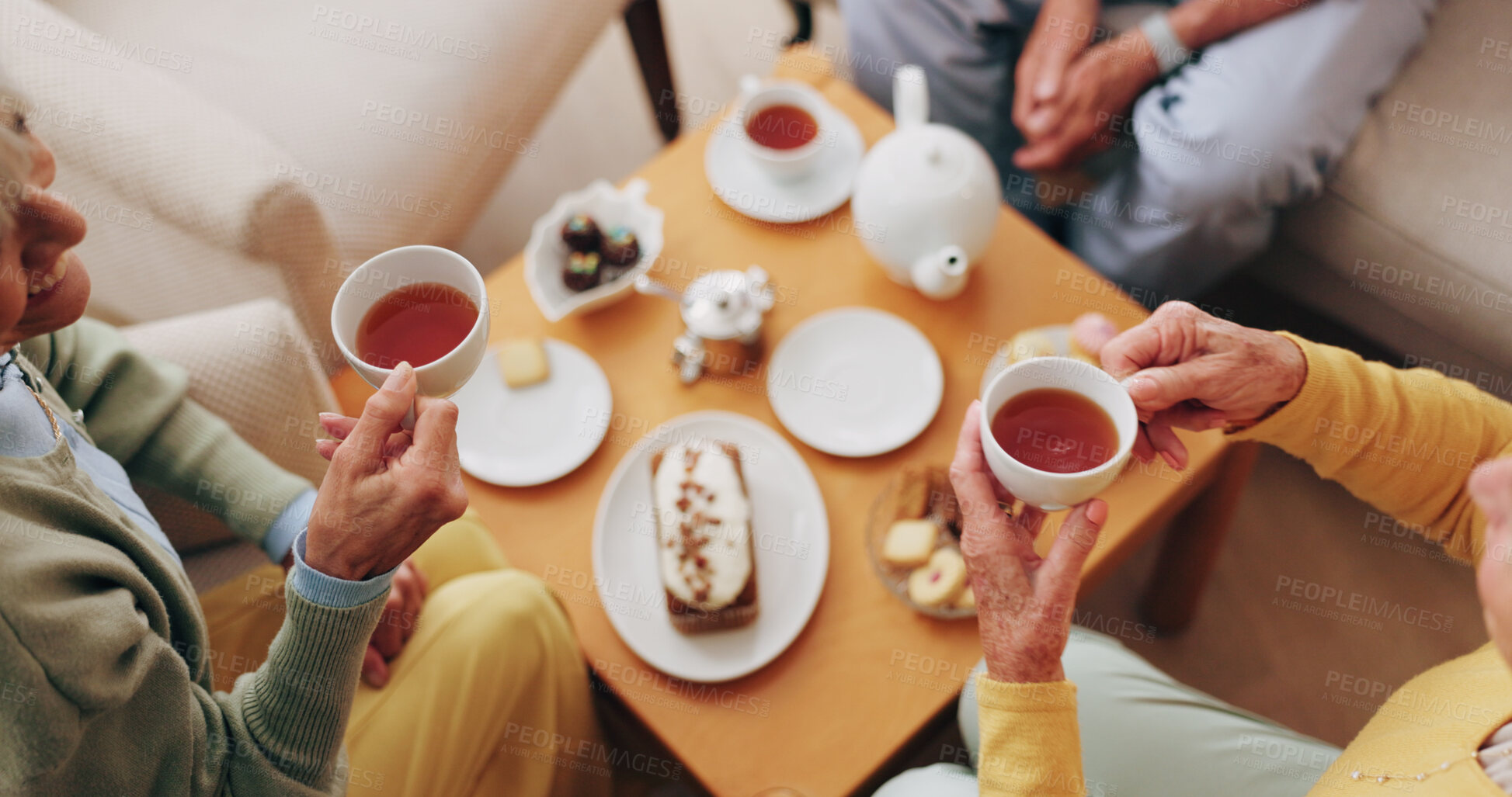Buy stock photo Senior, hands and friends with tea party in home for social gathering, supportive community and chat. Above, people and drink with cake in house for conversation, retirement bonding and weekend visit