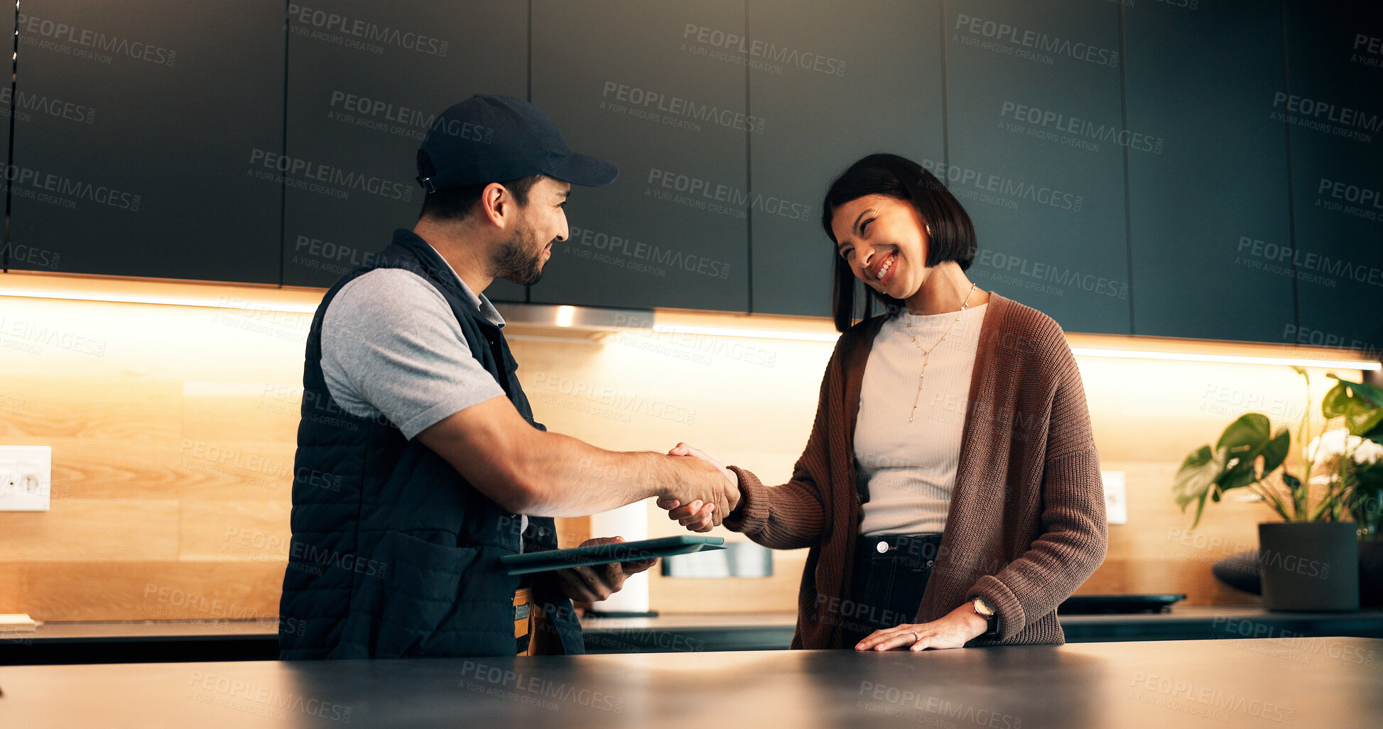 Buy stock photo Handshake, client and tablet with handyman in kitchen for invoice agreement, repair plan and consulting. Plumbing solution, home renovation quote and shaking hands with people for online feedback