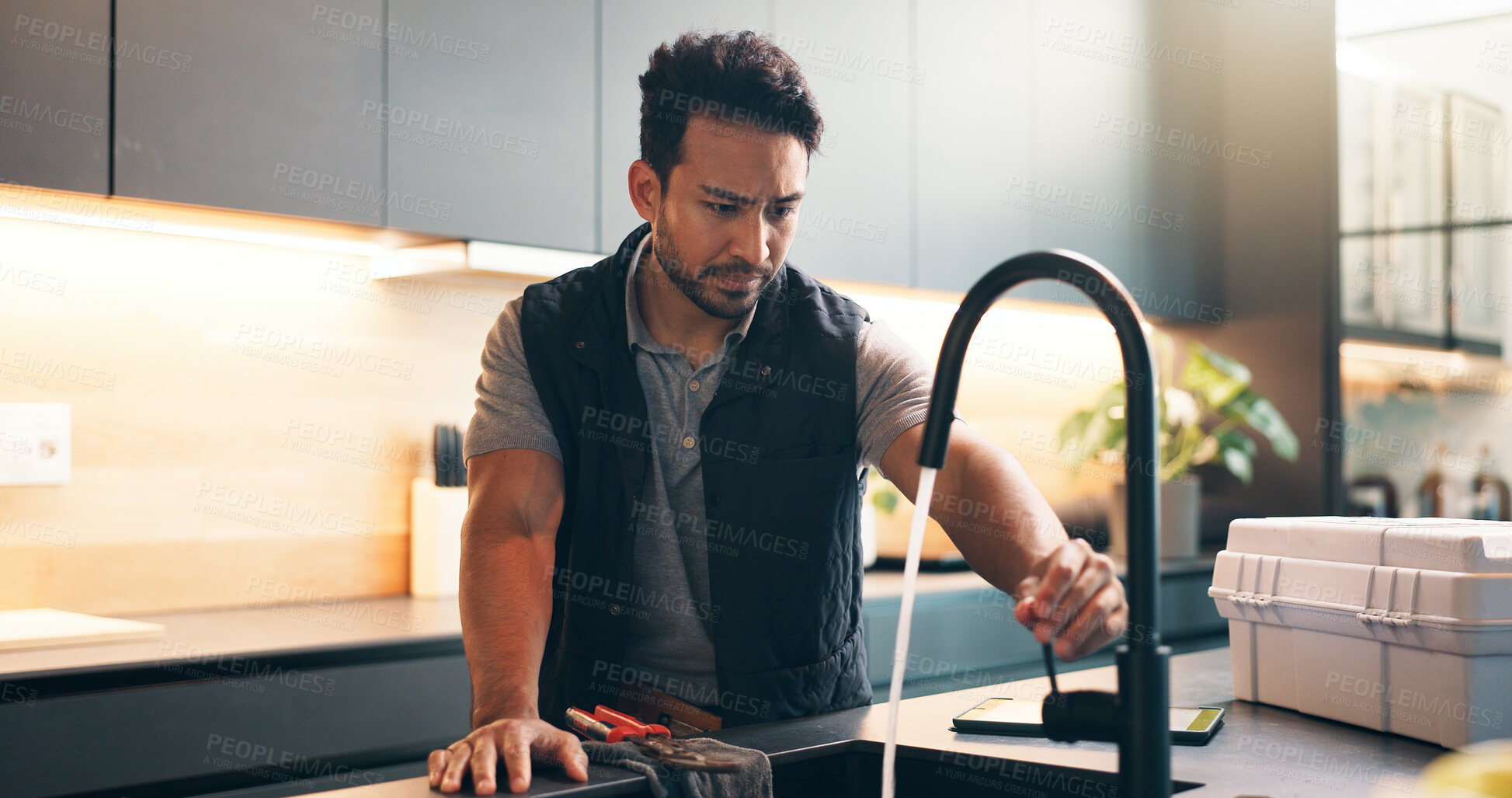 Buy stock photo Faucet, sink and man in kitchen for plumbing service, maintenance and repair in home. Handyman, house and person with equipment, inspection and check water flow for fixing, installation or renovation