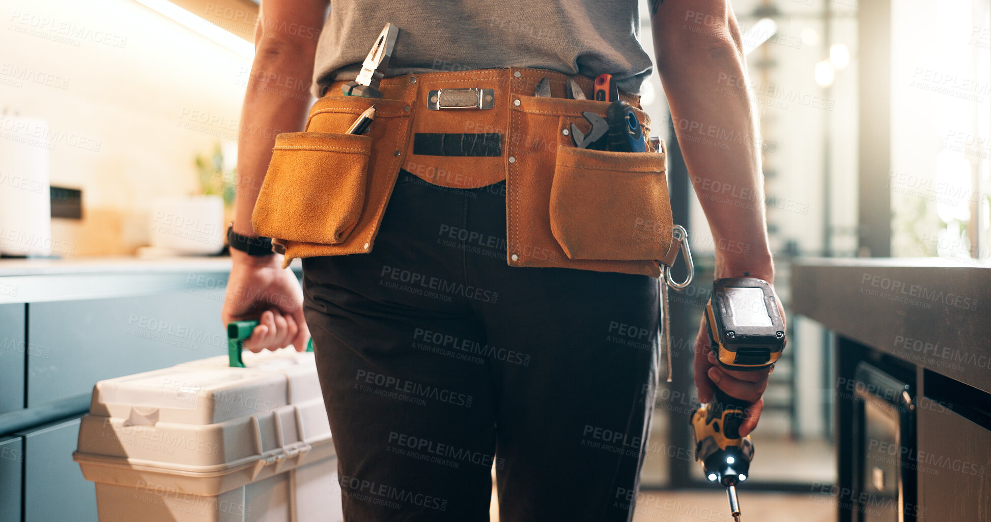 Buy stock photo Handyman, tools and back of man in kitchen for plumbing service, maintenance and repair in home. Walking, house and person with utility belt, equipment and toolbox for project, renovation and fixing
