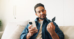 Credit card, phone and man on sofa for online shopping, digital purchase and internet banking. Happy, home and person on mobile app for debit info for ecommerce, subscription and discount on website