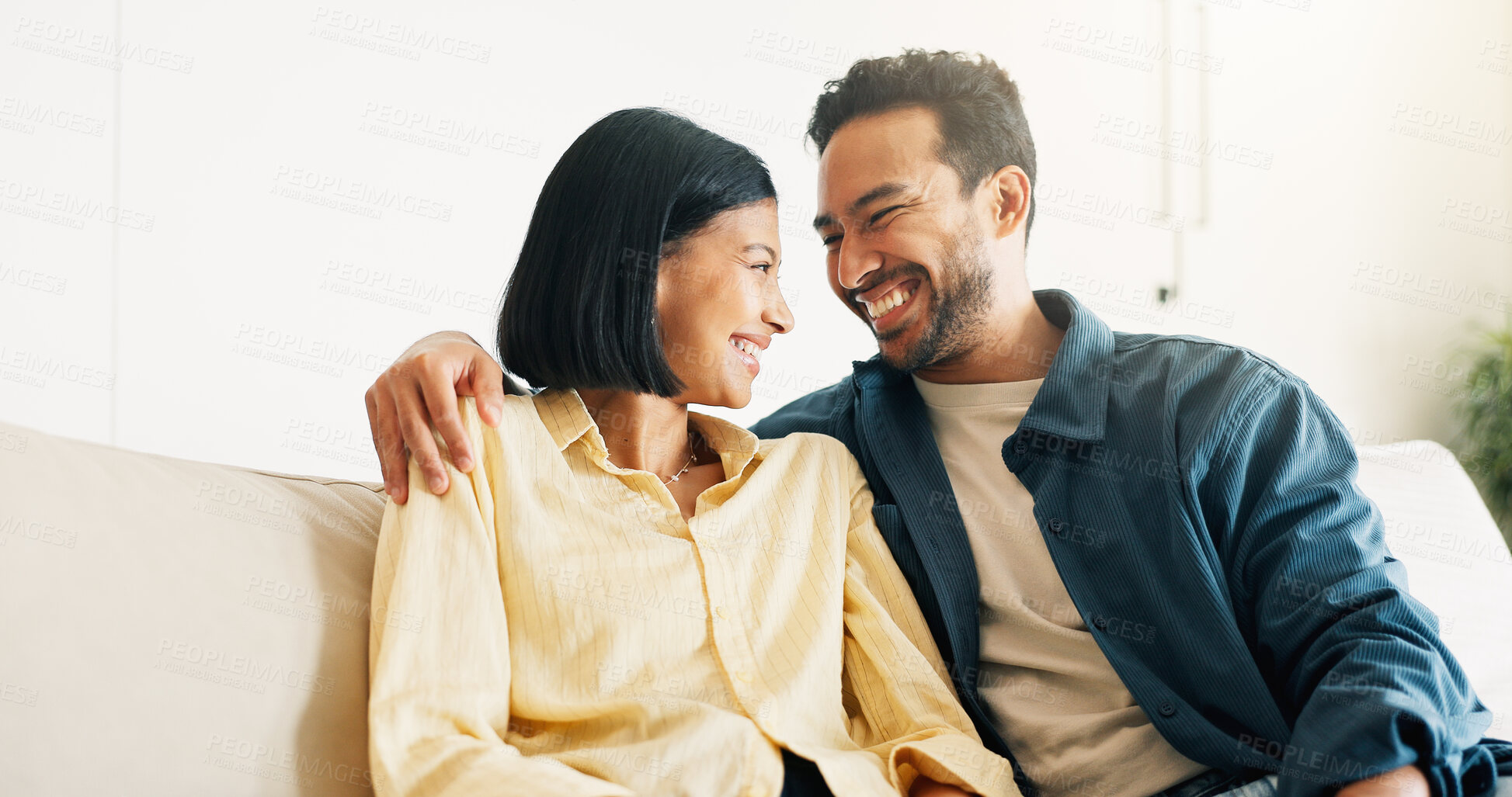 Buy stock photo Happy, relax and couple on sofa in home with bonding, love and connection in marriage on weekend. Smile, trust and man embracing woman in living room for commitment, care and affection in house.