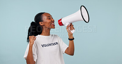 Buy stock photo Volunteer, bullhorn and black woman in studio for awareness campaign on a blue background. Female person, happy helper or activist with megaphone or fist pump for announcement or charity donation