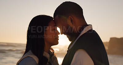 Buy stock photo Love, sunset and couple at beach with connection, loyalty and care on summer vacation getaway. Man, woman and forehead touch with happy partner by sea for interracial relationship romance or support