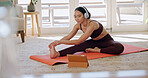 Yoga, headphones and woman in house with tablet, video tutorial and online routine with streaming. Watching, stretch and person on mat with technology, health guide or virtual wellness on digital app
