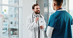Doctor, nurse and conversation in hospital with advice, medical team and partnership for patient care. Happy, men and discussion in clinic with collaboration, opinion and suggestion for healthcare.