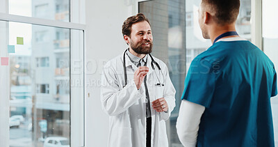 Buy stock photo Doctor, nurse and conversation in hospital with advice, medical team and partnership for patient care. Happy, men and discussion in clinic with collaboration, opinion and suggestion for healthcare.