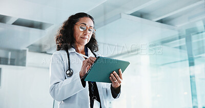 Buy stock photo Reading, doctor and woman with tablet in hospital for insurance report, healthcare or scroll email. Mature, medical professional and digital tech for results, review or research information in clinic