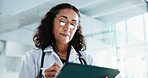 Doctor, woman and writing with tablet in hospital for insurance report, reading or scroll email. Mature, medical professional and digital tech for results, review or research information in clinic