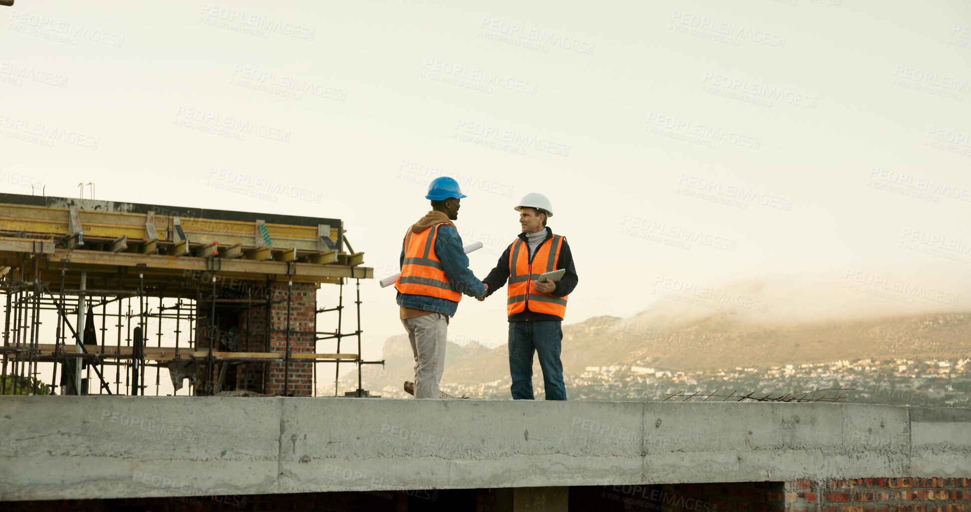 Buy stock photo Handshake, construction and men on rooftop for meeting, agreement and approval for architecture. Engineering, contractor and people shaking hands for building project, planning and infrastructure