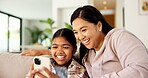 Mother, child and laugh in home with phone, play online game and bonding together on weekend break. Happy, woman and daughter relax in living room with tech, gaming website and humor for connection.