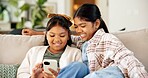 Children, sisters and game in home with phone, entertainment and bonding together on weekend break. Happy, kids and siblings relax in living room with tech, gaming website and internet connectivity.