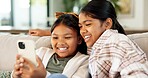 Children, relax and watching with phone in home for weekend, bonding or streaming together. Girls, sisters or siblings with smile, smartphone or app for online entertainment or cartoon in house