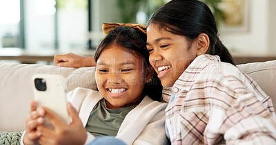 Buy stock photo Children, relax and watching with phone in home for weekend, bonding or streaming together. Girls, sisters or siblings with smile, smartphone or app for online entertainment or cartoon in house