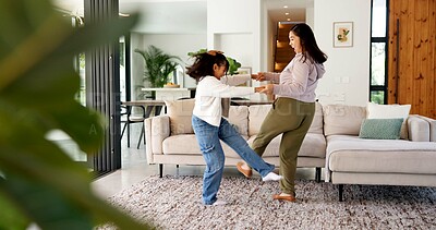 Buy stock photo Happy, mom and dancing with child in home for bonding, weekend or fun energy together. Mother, girl or daughter holding hands with playful kid for vibe, holiday celebration or vacation in house