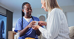 Caregiver, support and coffee in nursing home for old woman, medical assistance and wellness checkup. Nurse, help and senior person in living room with tea, kindness and healthcare for retirement.