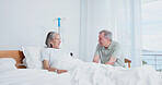 Senior, couple and serious visit at hospital bed for recovery concern, surgery complication or worry. Marriage, elderly people and talk in clinic ward for functional decline, stress or discharge risk