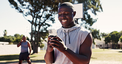 Buy stock photo Fitness, app and phone with man on basketball court for message, tracker and social media. Summer, communication and training with person in park for health, digital tech and sports planning outdoor