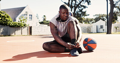 Buy stock photo Fitness, start or athlete on basketball court with shoelace, ready or footwear safety in practice session. Secure, prep or black man with lace tie, sportswear check or injury prevention in ball sport