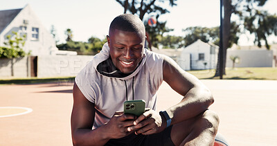 Buy stock photo Fitness, app and phone with black man on basketball court for message, tracker and social media. Summer, communication and training with happy person in park for health, tech and sports planning