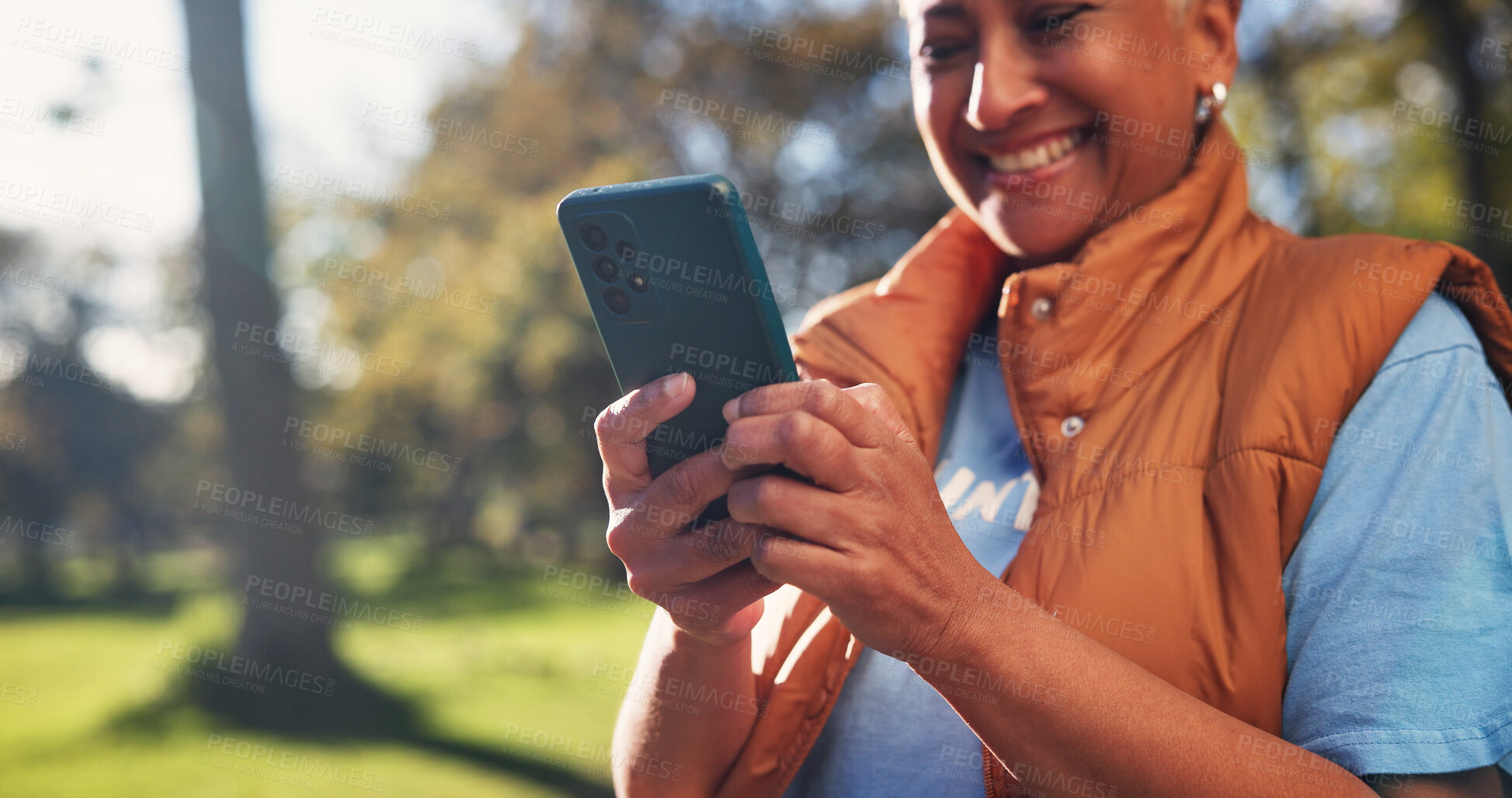 Buy stock photo Cellphone, woman and volunteer in nature for email feedback on community outreach or NGO project. Happy, outdoor and mature charity worker with phone for texting of contact for non profit update.