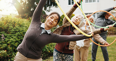 Buy stock photo Trainer, senior people and hoop for stretching outdoor, exercise or mobility wellness. Elderly care, health and fitness with plastic ring for warm up, body movement and woman with group in retirement