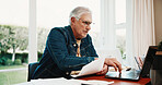 Serious, old man and reading at house with laptop, research and finance report for mortgage loan. Senior person, typing or pc in home with documents, pension claim and financial information for audit