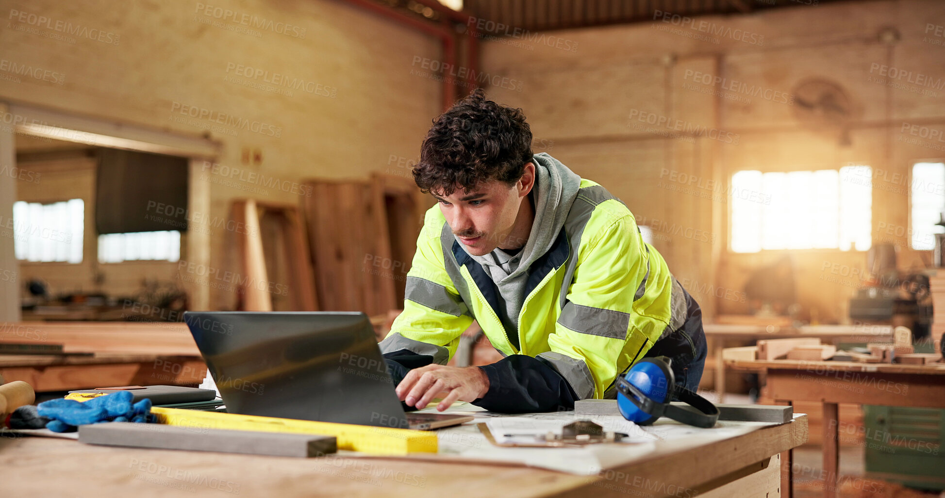 Buy stock photo Construction, laptop and typing with man in carpentry workshop for lumber or timber supply. Computer, planning and review with carpenter in woodworking factory for online order of building material