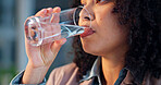 Woman, water and drinking with glass in office for hydration, sustainability or refreshment. Female person, hands and mineral liquid with aqua beverage for thirst, nutrition or vitamins in workplace