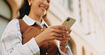Cellphone, happy and businesswoman in city with texting, feedback and email for finance report. Smile, technology and hands of financial advisor with phone for update on investment growth in town.