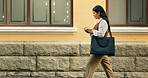 Phone, walking and businesswoman in city with texting, feedback and email for finance report. Commuting, technology and financial advisor with cellphone for update on investment growth in urban town.