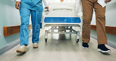 Buy stock photo Legs, doctor and nurse walk with hospital bed for patient, medical treatment and teamwork with help. People, feet and moving in clinic hallway with gurney, healthcare support and journey to surgery.