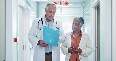 Buy stock photo Doctor, checkup and woman at hospital with folder, test results and medical history for diagnosis. Mature people, walk and consulting in lobby with document, patient discharge and healthcare records