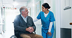 Conversation, nurse and senior man in wheelchair at hospital for consultation, healthcare or support. Happy, caregiver and elderly person with disability for medical checkup in clinic corridor.