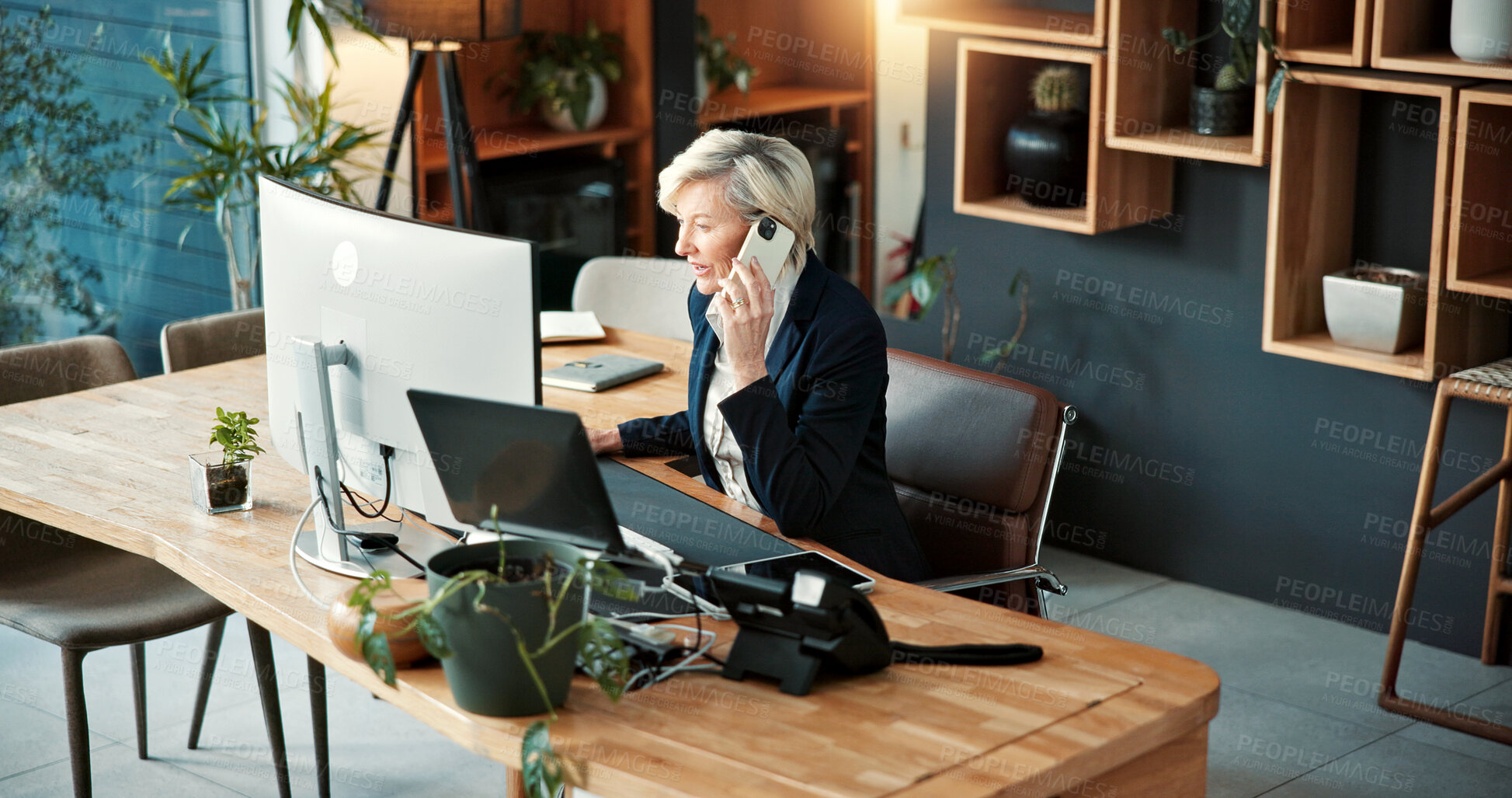 Buy stock photo Corporate, woman and phone call in office with computer, research and buyer approval for real estate. Above, mature realtor and mobile in workplace with pc, positive feedback and auction negotiation