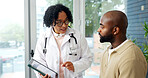 Doctor, tablet and conversation in clinic with patient, medical survey and questions about symptoms. Healthcare worker, tech and discussion in consultation with person, wellness evaluation or advice.