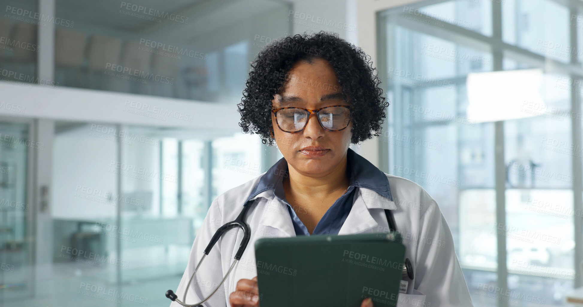 Buy stock photo Tablet, doctor and woman in hospital for medical research, case study and admin with email. Serious, healthcare and mature person with tech to review guidelines, history or electronic health records
