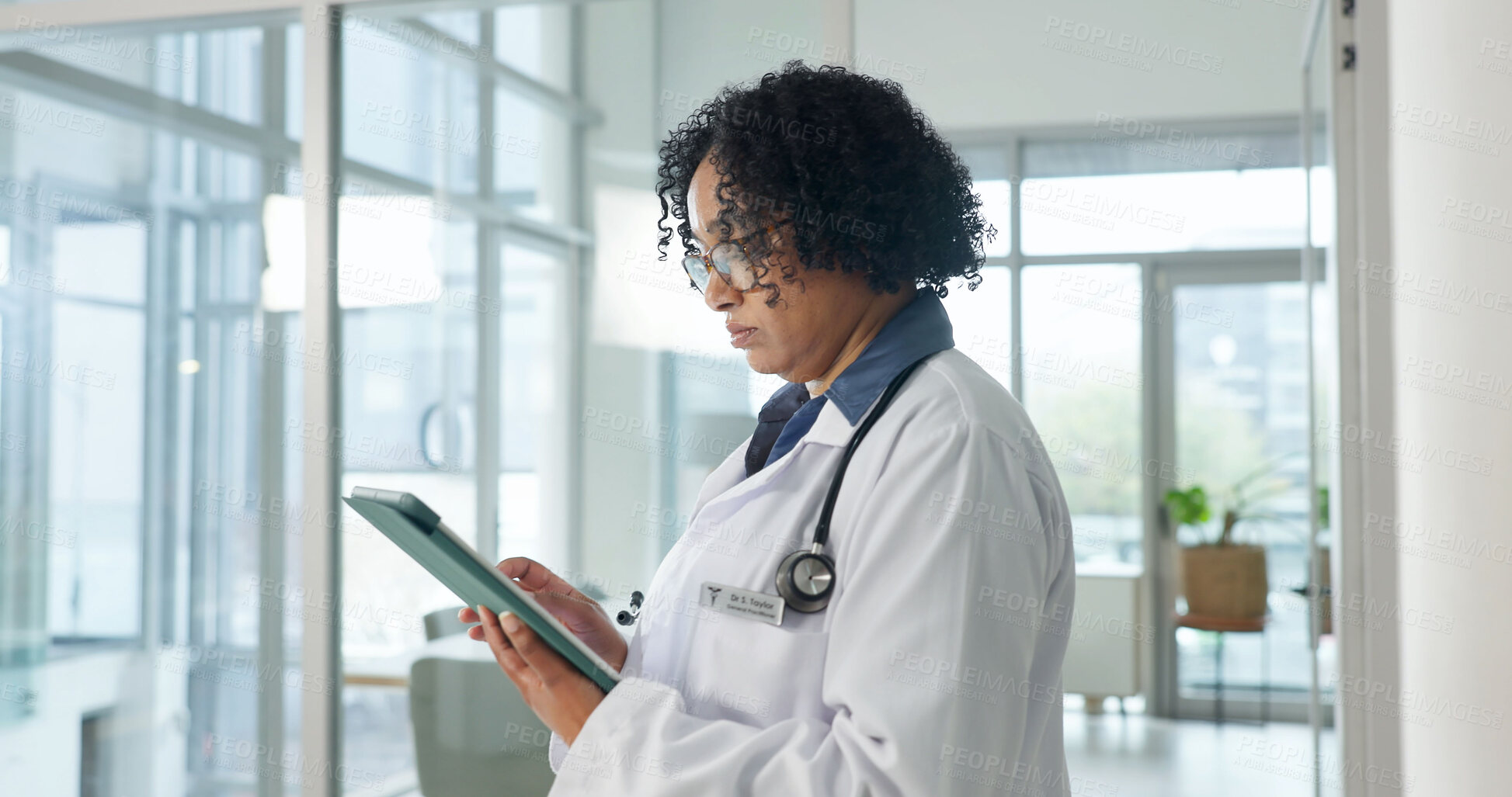 Buy stock photo Tablet, doctor and serious woman in clinic for medical research, assessment report and admin email. Checklist, hospital or mature person with tech to review diagnosis, test info or healthcare records
