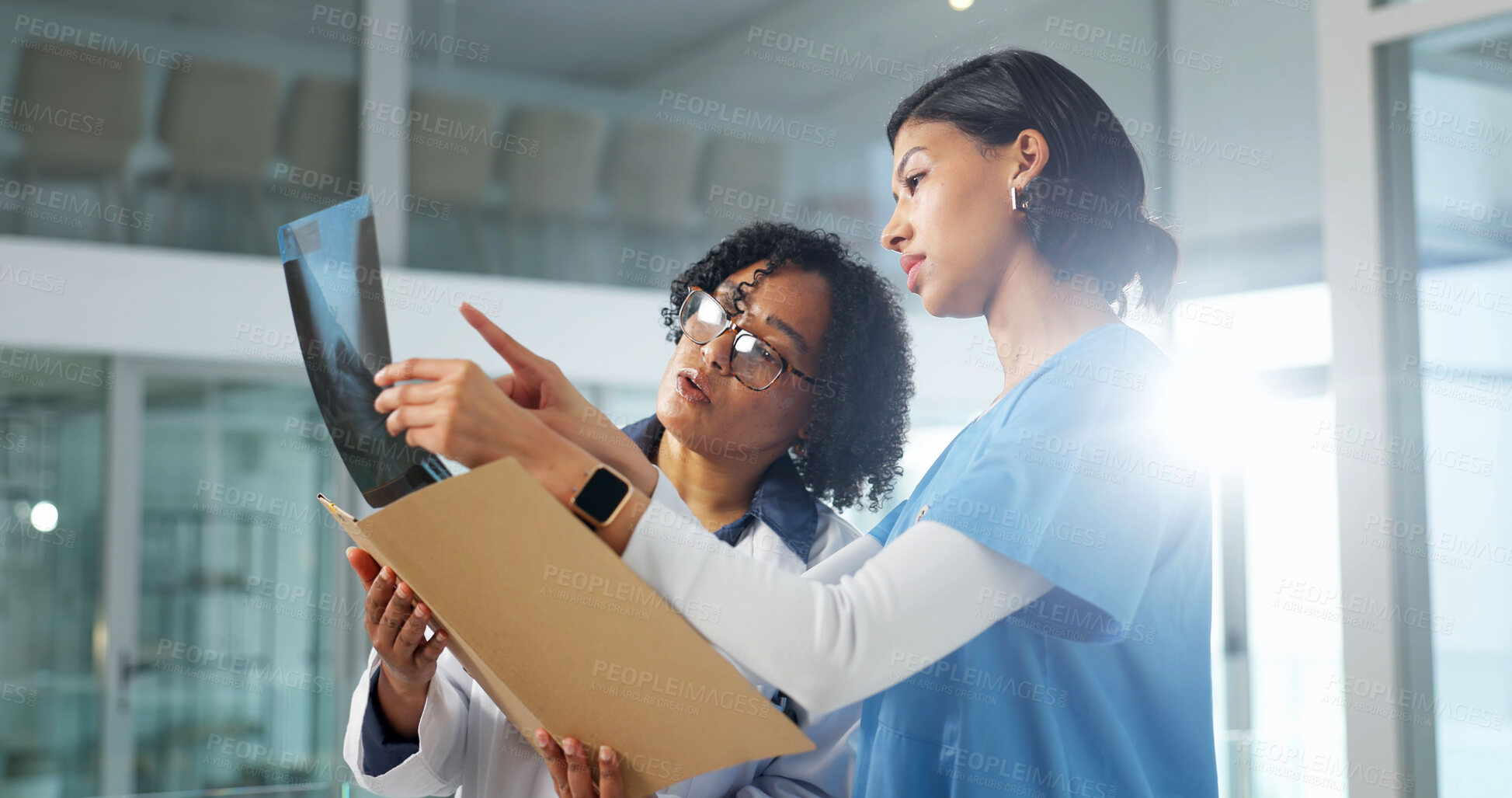 Buy stock photo Doctor, nurse and review xray in hospital, advice and feedback for medical treatment with specialist. Woman, surgeon and radiology scan for healthcare, guide or help for diagnosis at clinic flare