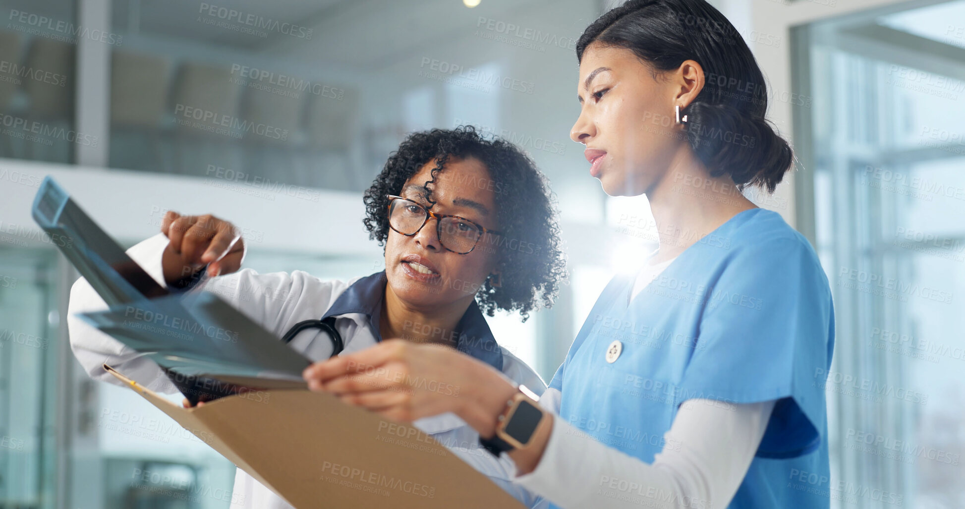 Buy stock photo Doctor, nurse and review xray in clinic, advice and feedback for medical treatment with specialist. Woman, surgeon and radiology scan for healthcare, guidance or help for diagnosis at hospital