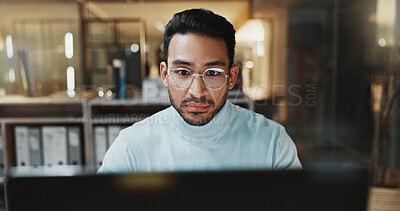 Buy stock photo Employee, online and man with laptop in office, budget review and financial plan with info at night. Accountant, working late and person with tech, serious and checking expenses on web in business