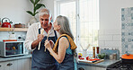 Karaoke, cooking and mic with old couple in kitchen for bonding, love and meal prep. Connection, support and food with senior man and woman and spoon in home for retirement, singing and music