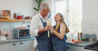 Buy stock photo Karaoke, cooking and laugh with old couple in kitchen for bonding, love and meal prep. Connection, support and food with senior man and woman and spoon in home for retirement, singing and music